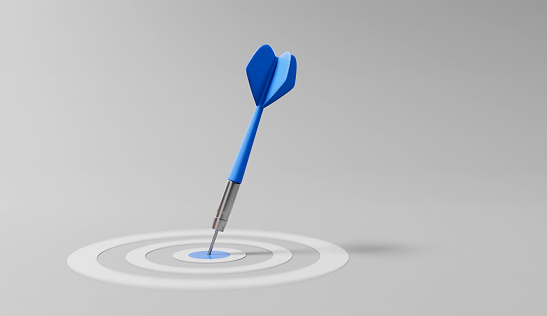 Successful young man playing darts, focusing on his aim