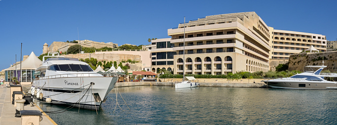 Valletta, Malta - 3 August 2023: Panoramic view of boats moored in the private marina of the luxury Excelsior Hotel in the city of Valletta