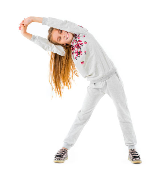 istock Little girl doing side bend isolated on a white background 1665753455