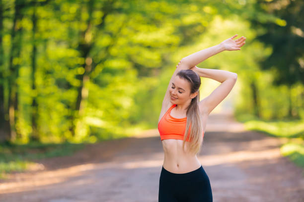 Woman with long hair training outdoor. female doing stretching exercise. Close up. People, fitness and healthcare concept