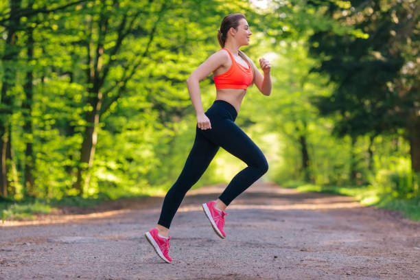 istock Young fit woman does running, jogging training in a park at summ 1665755137