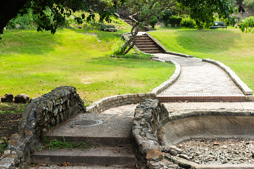 This is a photograph of a stone staircase leading through the grass on a summer day in Washington Park in Macon, Georgia.