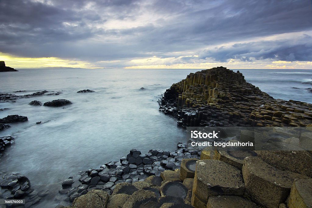 Beautiful sunset at the famous Giant's Causeway Beautiful sunset at the famous Giant's Causeway - on the Antrim coast of Northern Ireland. Basalt Stock Photo