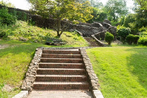 This is a photograph of a stone staircase leading up the hill on a summer day in Washington Park in Macon, Georgia.