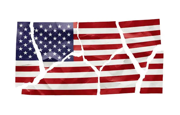 Stars and Stripes printed on paper and ripped into jagged pieces, representing political and social divisions.