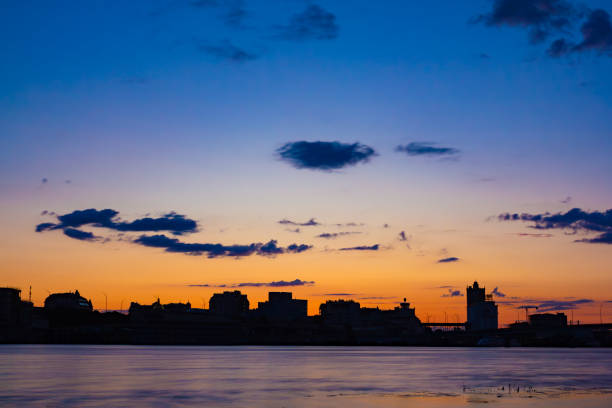 istock Twilight Reflections: Sunset over Cityscape and River 1665771226