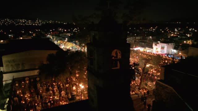 high angle view of a church in a well lit cemetery during day of the dead in Mexico