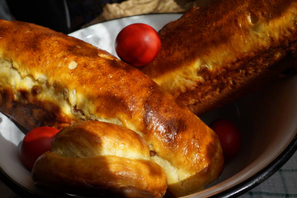 istock Easter Romanian bread. Traditional sweet bread and red eggs for Easter. Sponge cake cozonac out of the oven 1665802881