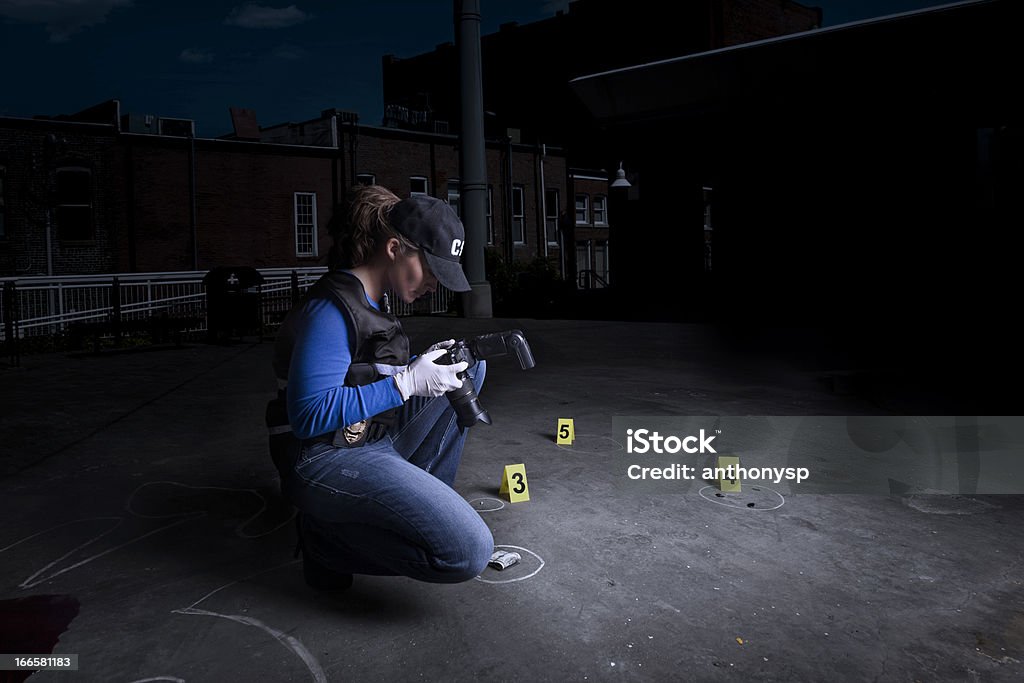 crime town A female crime scene investigator (CSI) with evidence, camera and markers. Forensic Science Stock Photo