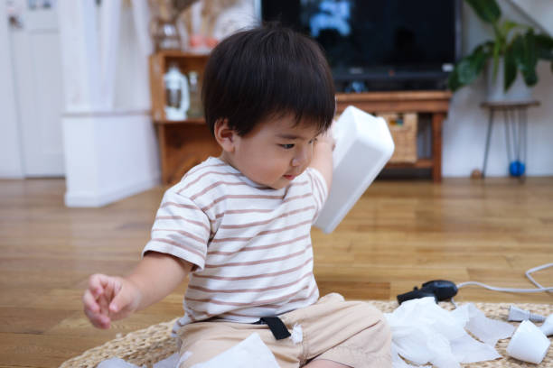 istock Curious baby boy plays with rubbish 1665812491