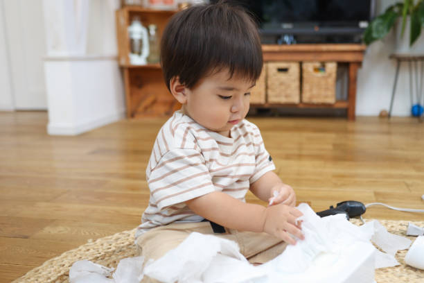 istock Curious baby boy plays with rubbish 1665812520