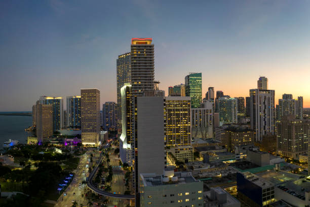 istock Downtown district of Miami Brickell in Florida. Skyline with illuminated high skyscraper buildings and street with cars and Metrorail traffic in modern american megapolis 1665828887