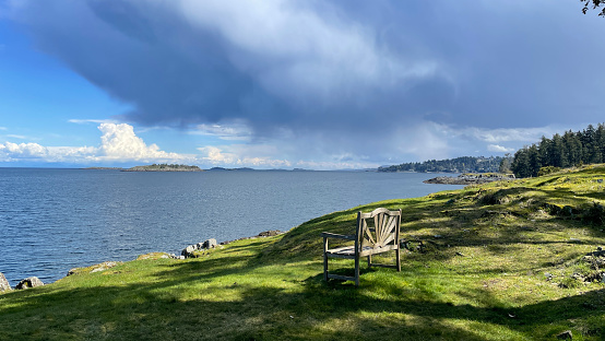 A bench looking at the Pacific Ocean on the East Coast of Vancouver Island in Nanoose Bay, British Columbia, Canada.