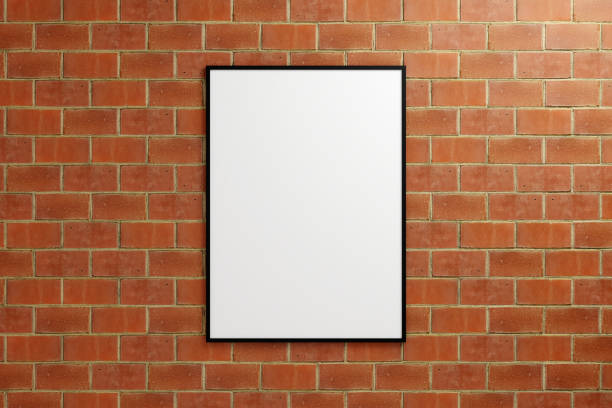 istock Minimalist hanging vertical black poster or photo frame mockup in brick wall. 3D Rendering. 1665836205