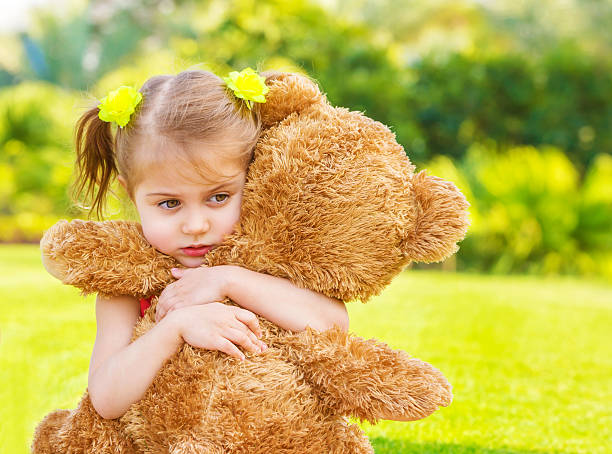 istock Sad girl with teddy bear 166584560