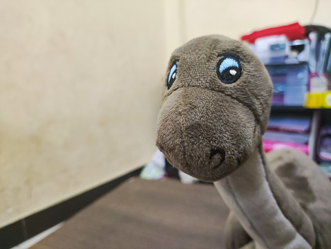 close up of a doll in the shape of a brontosaurus