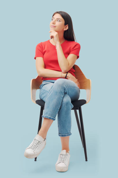 Young woman sitting and thinking stock photo