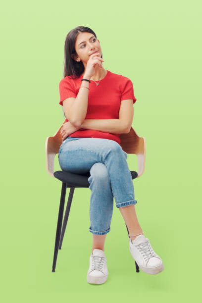 istock Young woman sitting and thinking 1665857569