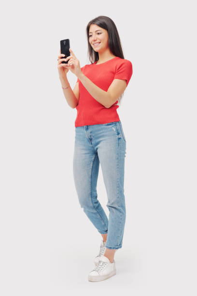 istock Happy young woman using a smartphone 1665859205