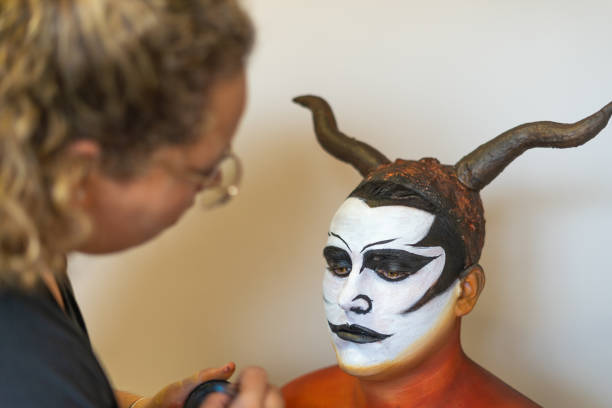 detail of facial make-up and characterization of a devil - face paint human face mask carnival imagens e fotografias de stock