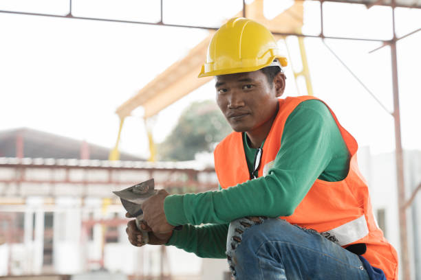 istock Asian male builder worker working at construction site. Male mason working at construction site 1665902897