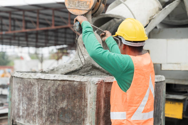 istock Construction workers pouring wet concrete by concrete bucket for building precast concrete wall at construction site 1665903450