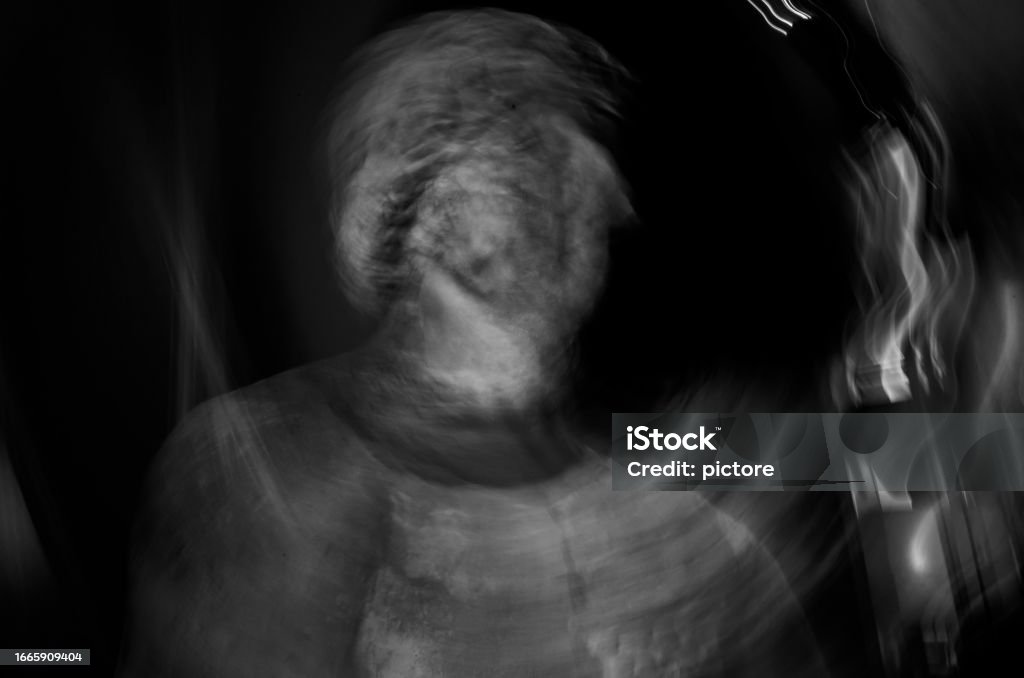 ANCIENT GREEK GOD IN MOTION BLUR Bust of an ancient Greek god from the period of antiquity. Motion blur in black and white Adulation Stock Photo