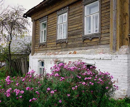 Saint Petersburg, Russia - Oct 18, 2016. Old wooden house with small garden.