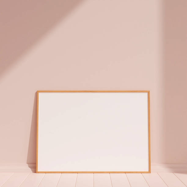 istock Clean and minimalist front view horizontal wooden photo or poster frame mockup leaning against the wall with shadow. 3d rendering. 1665923249