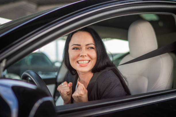 istock Pleasant looking female with glad positive expression sitting on driver seat, using safety belt. Lifestyle and success concept 1665923480