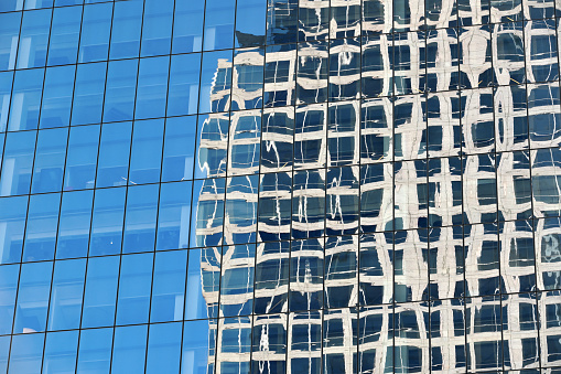 Reflections in the curtain wall of an office building.