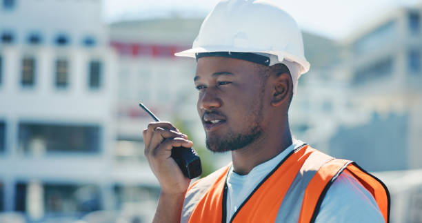 istock Communication, radio and construction worker, black man or manager for project management in urban city. Engineering contractor speaking of architecture or building safety check on walkie talkie 1665924930