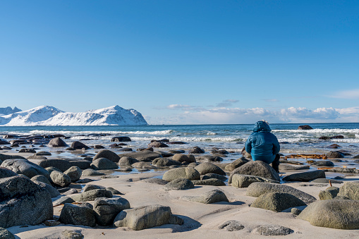 Senior men on the beach at Utakleiv beach, winter, Steinsfjorden. Vestvagoya-Nordland fylke-Norway.