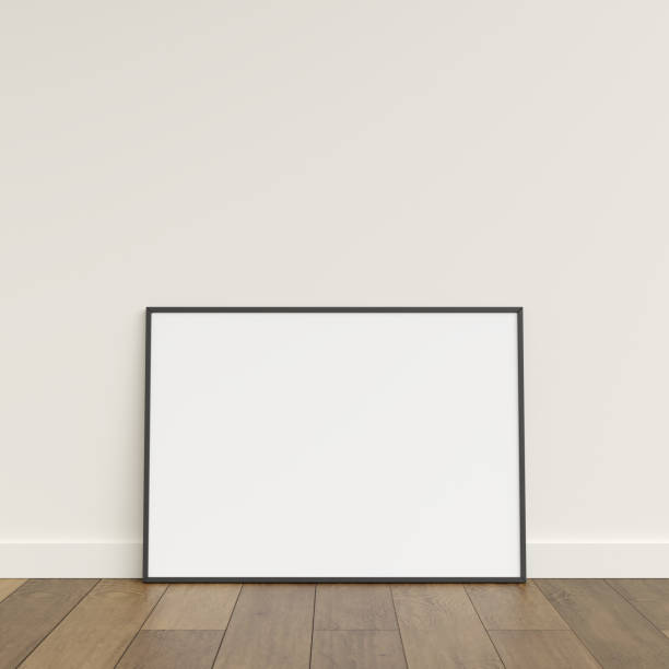 istock Empty picture frame on wooden floor leaning against wall. Blank poster frame standing on wooden floor. Blank poster frame mockup. Empty picture frame mockup. 3d rendering. 1665955306