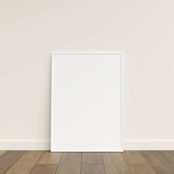 istock Empty picture frame on wooden floor leaning against wall. Blank poster frame standing on wooden floor. Blank poster frame mockup. Empty picture frame mockup. 3d rendering. 1665955311