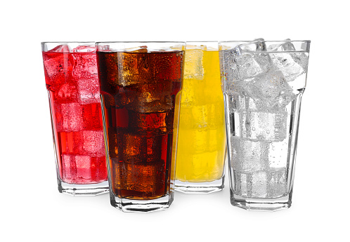 Glasses of different refreshing soda water with ice cubes isolated on white