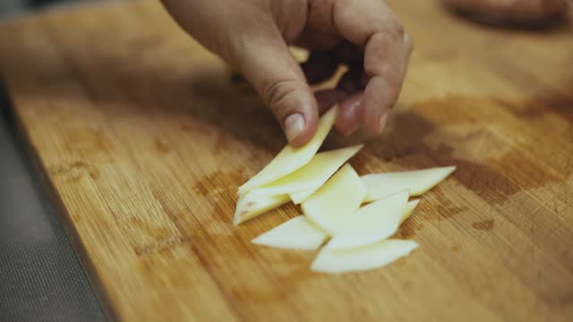 Preparing a meal, cutting ginger.