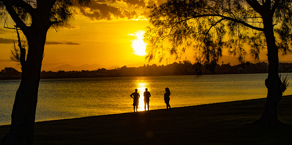 Nice sunset with 3 people silhouette