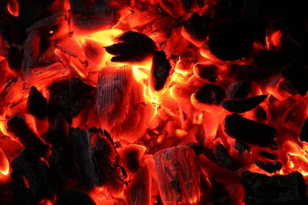 Pieces of hot smoldering coal as background, top view