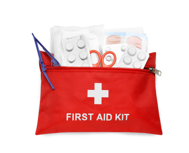 istock Red first aid kit with scissors, pills, plastic forceps and medical plasters isolated on white, top view 1665969459