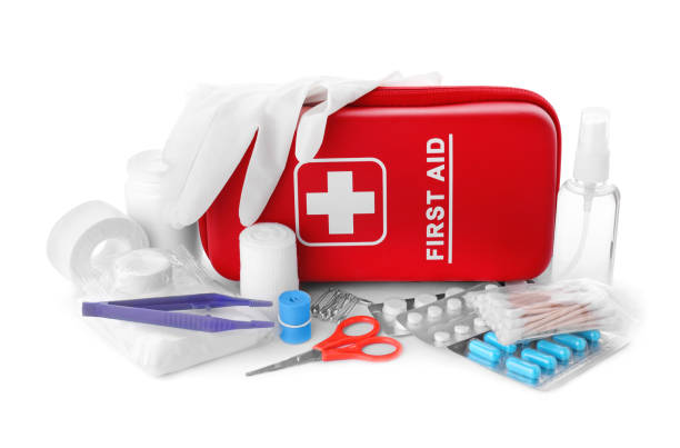 istock First aid kit, scissors, gloves, pills, cotton buds, plastic forceps, hand sanitizer and elastic bandage on white background. Health care 1665969469