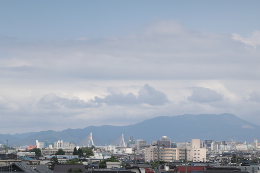 Aomori City, Japan - June 10, 2023: View looking east across Aomori City on a spring afternoon. Scenic mountains stand in the background. Spring afternoon in the Tohoku Region.