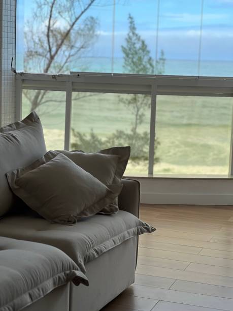 istock Neutral living room facing the sea 1665981499