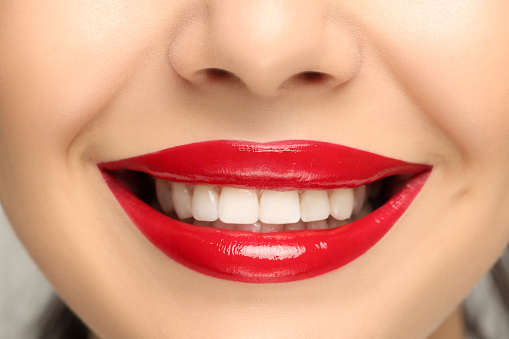 Smiling woman with healthy teeth, closeup view