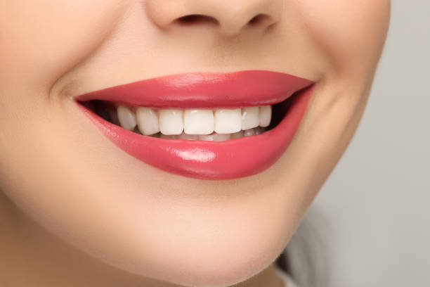 istock Smiling woman with healthy teeth on light background, closeup 1666011379