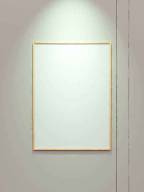 istock Minimal wooden vertical picture poster frame mockup on white wallpaper with spotlight 1666043264