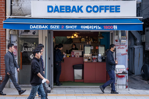 Seoul, South, Korea - October 24, 2022: Pedestrians outside a cafe named Daebak Coffee. \