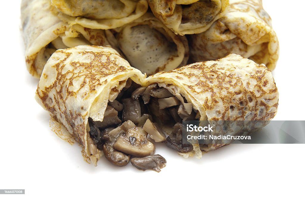 fried pancakes stuffed with fried pancakes with fried mushrooms on a white background isolated Baked Stock Photo