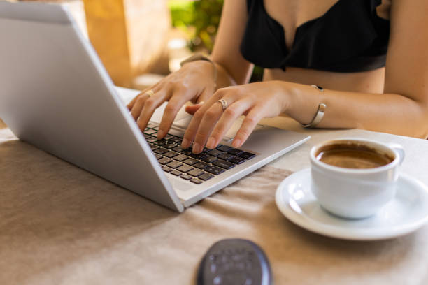 istock Modern Caucasian white female freelancer is working on laptop at hotel restaurant during her vacation. Traveling with a computer - Online dream job concept. Digital nomad. 1666087302