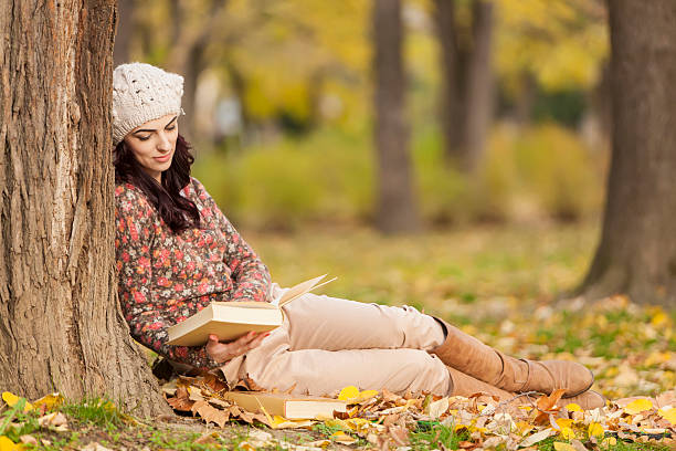 istock Young woman with a book in the forest 166609094